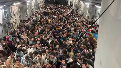 Hundreds of Afghans pack US military plane in desperate effort to escape the Taliban